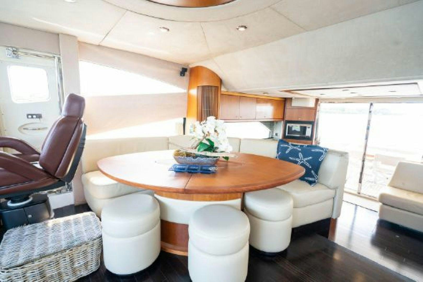 a dining table with chairs and a plant on it aboard SOLE MIO Yacht for Sale