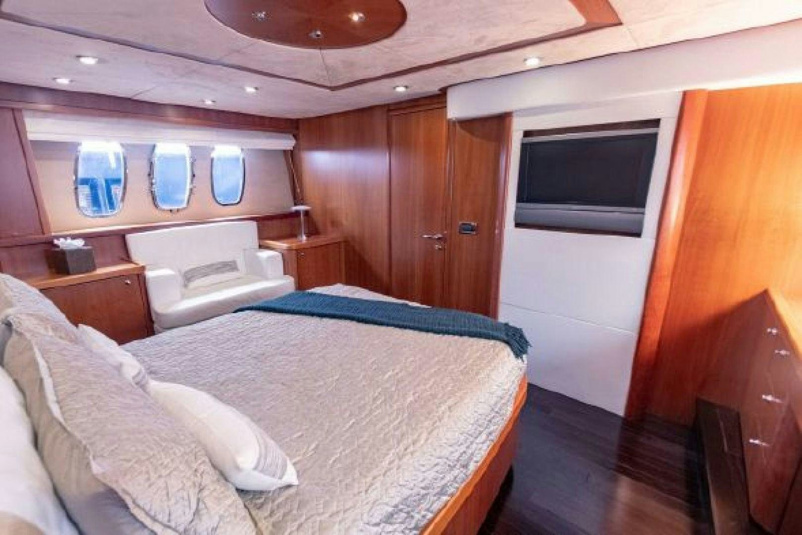a room with a bed and a television aboard SOLE MIO Yacht for Sale