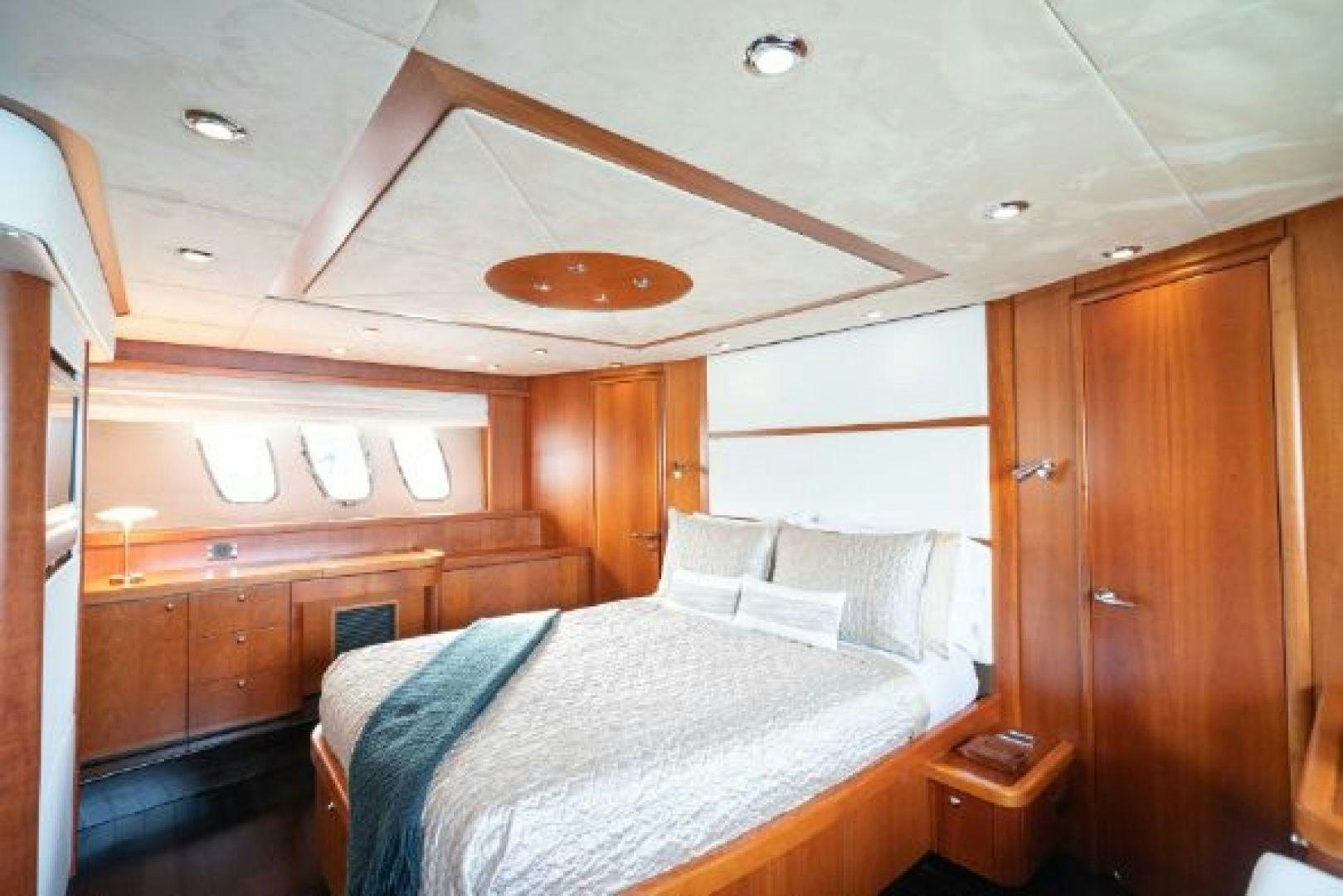 a bedroom with a bed and a ceiling fan aboard SOLE MIO Yacht for Sale