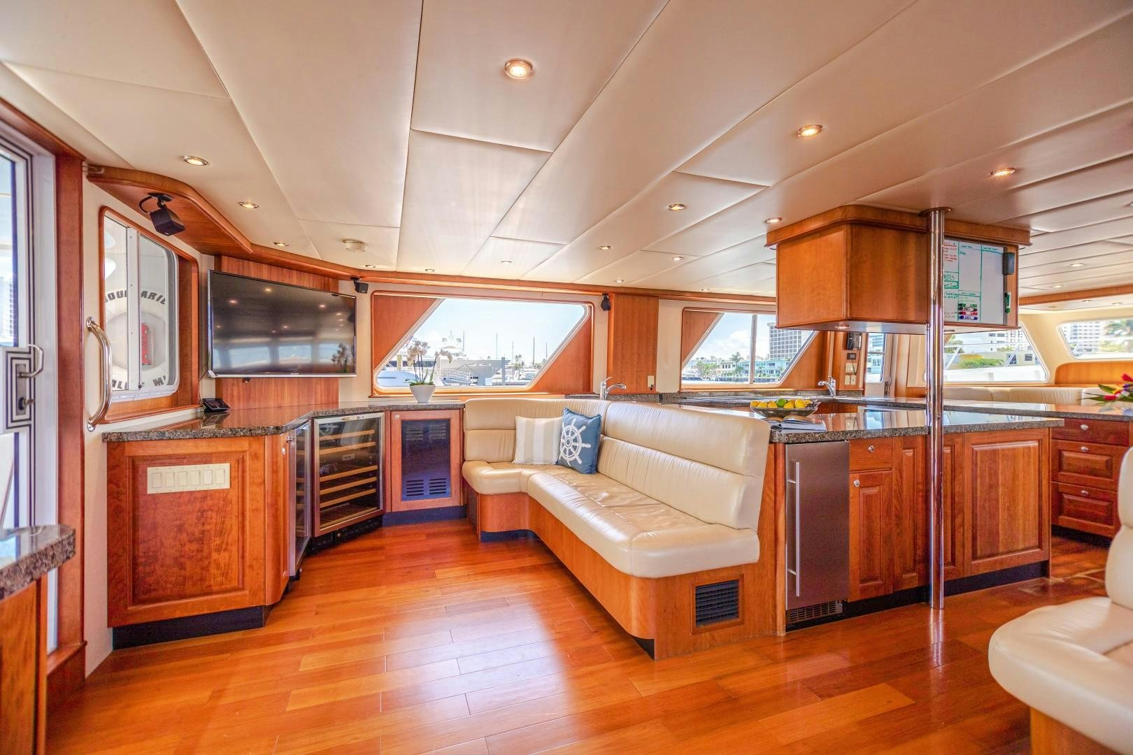 a large kitchen with a couch aboard NO BOUNDARIES Yacht for Sale