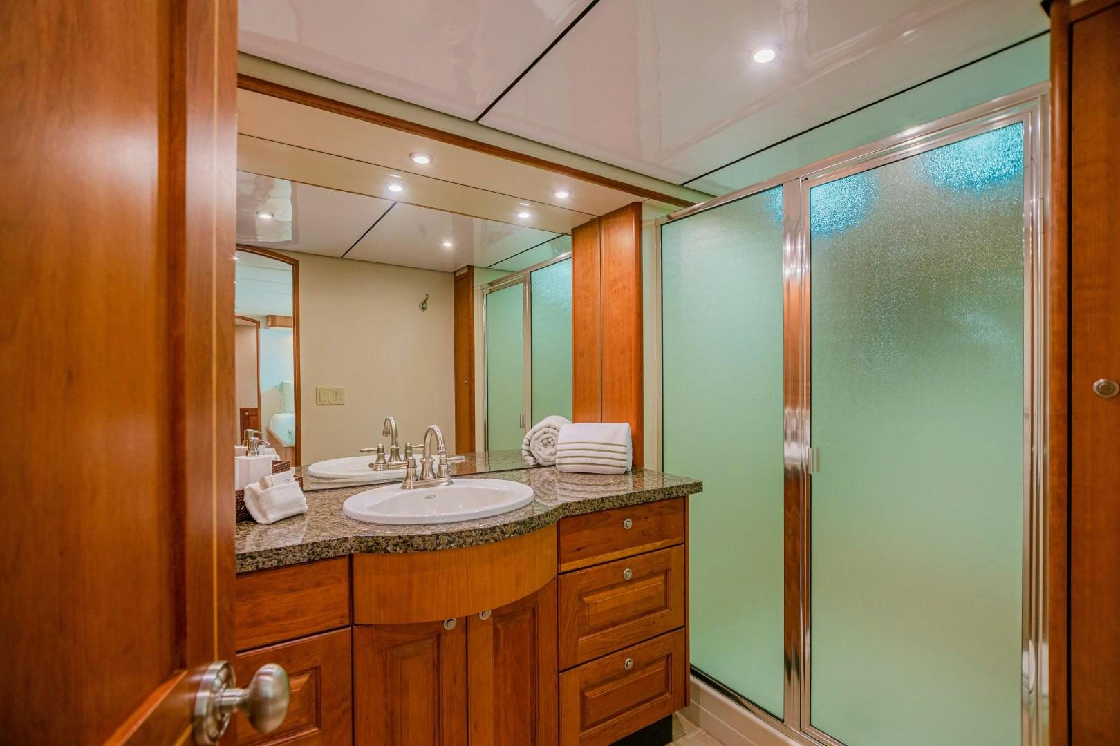 a bathroom with a sink and a mirror aboard NO BOUNDARIES Yacht for Sale