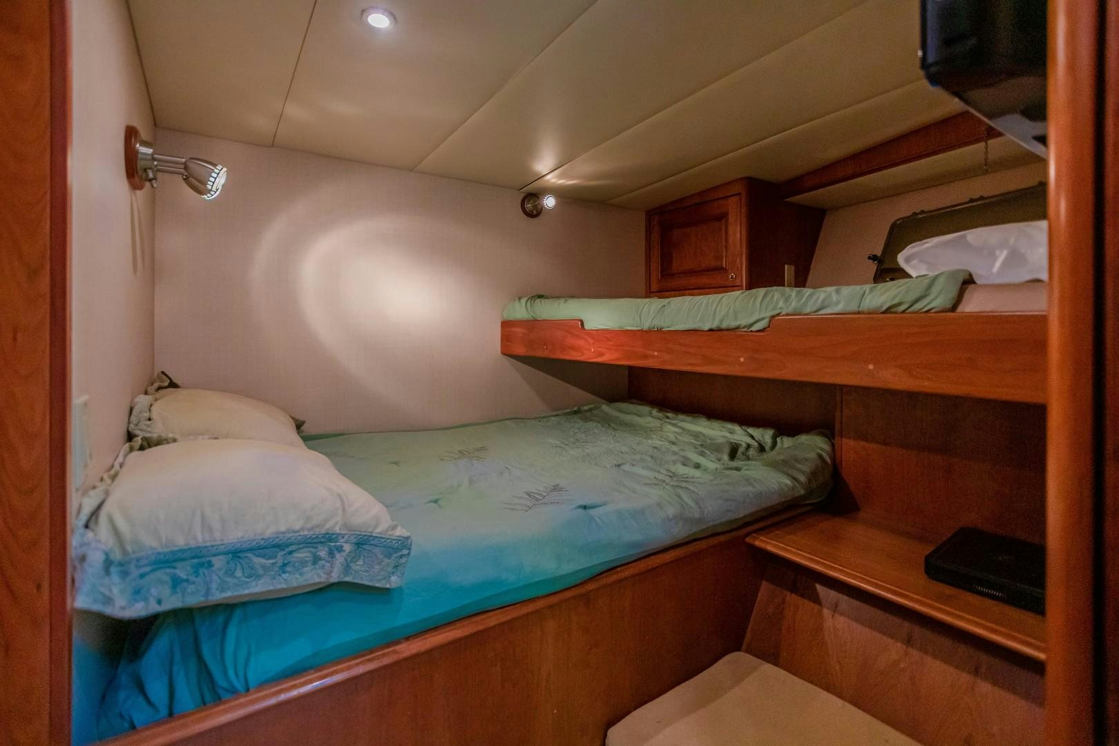 a couple of beds in a room aboard NO BOUNDARIES Yacht for Sale