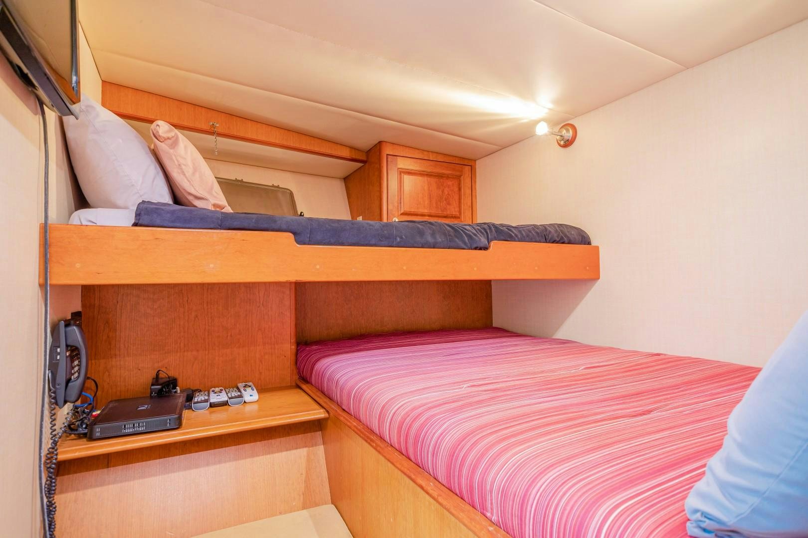 a bed with a pink sheet aboard NO BOUNDARIES Yacht for Sale