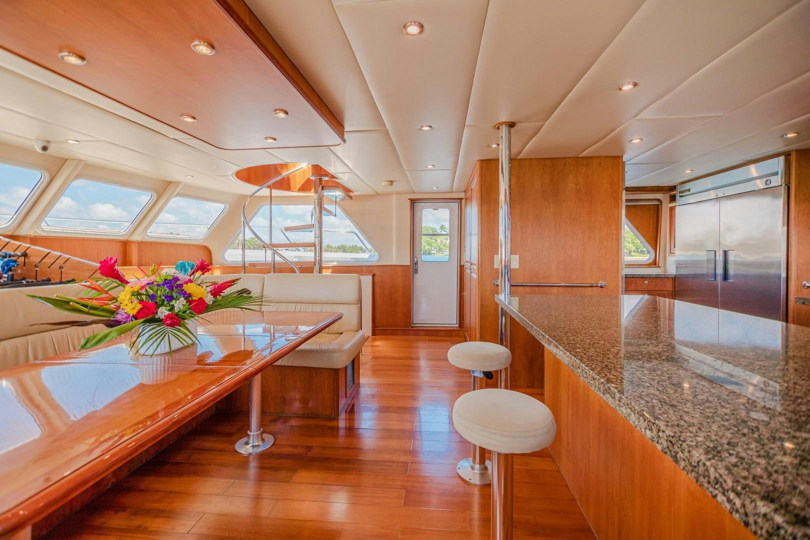 a kitchen with a table and chairs aboard NO BOUNDARIES Yacht for Sale