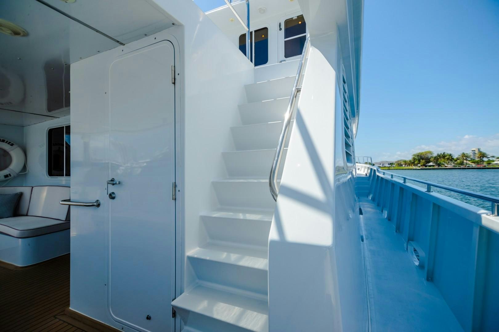 a white staircase leading to a pool aboard NO BOUNDARIES Yacht for Sale