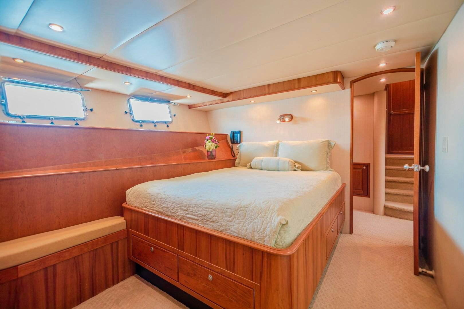 a room with a bed and a door aboard NO BOUNDARIES Yacht for Sale