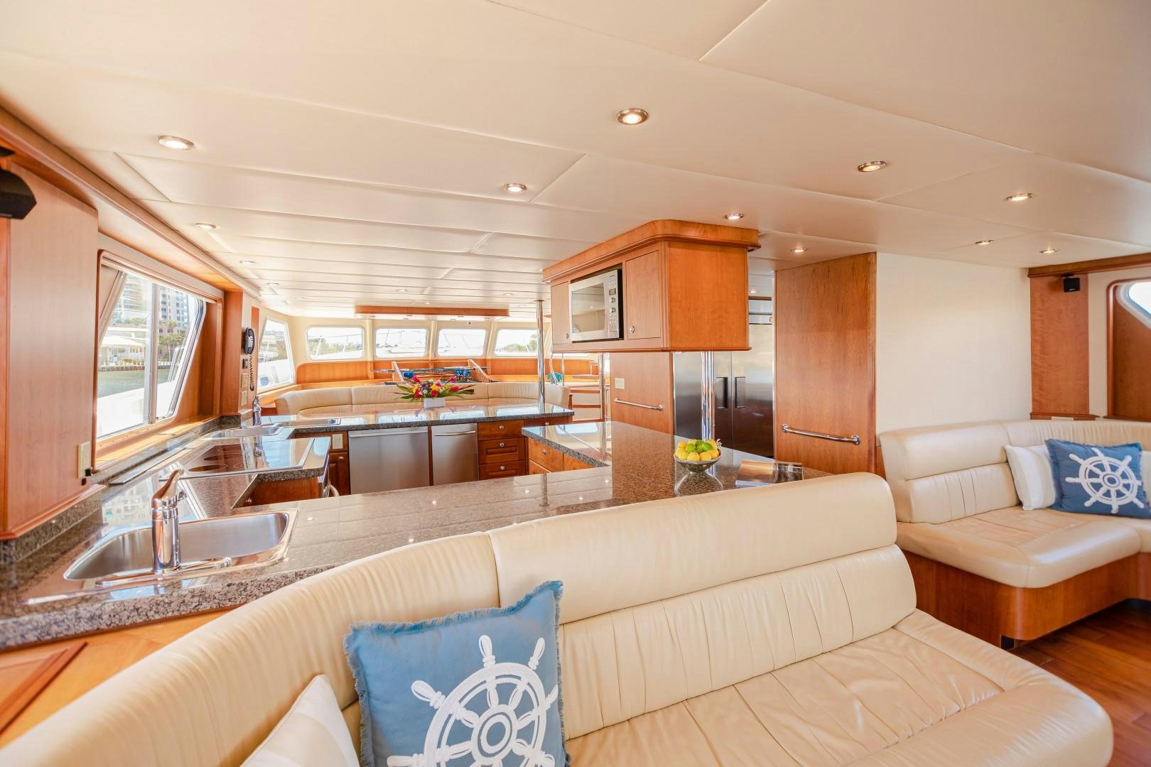 a living room with a large kitchen aboard NO BOUNDARIES Yacht for Sale