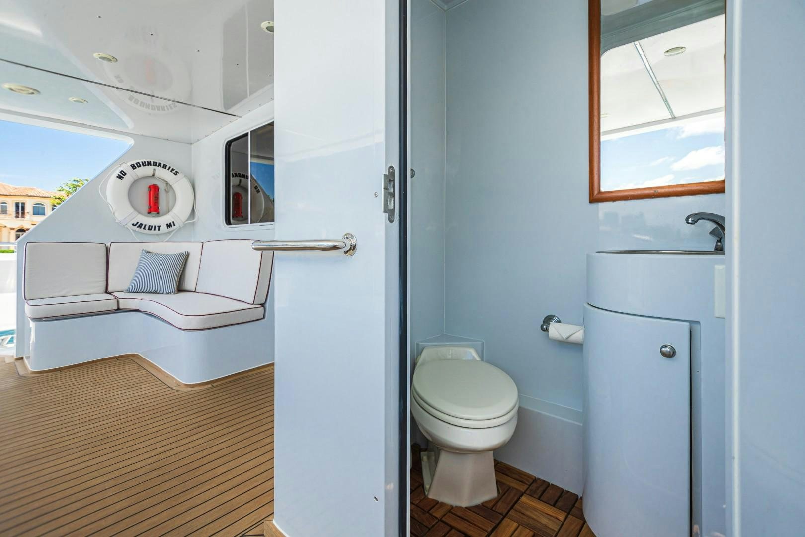 a small bathroom with a washing machine aboard NO BOUNDARIES Yacht for Sale