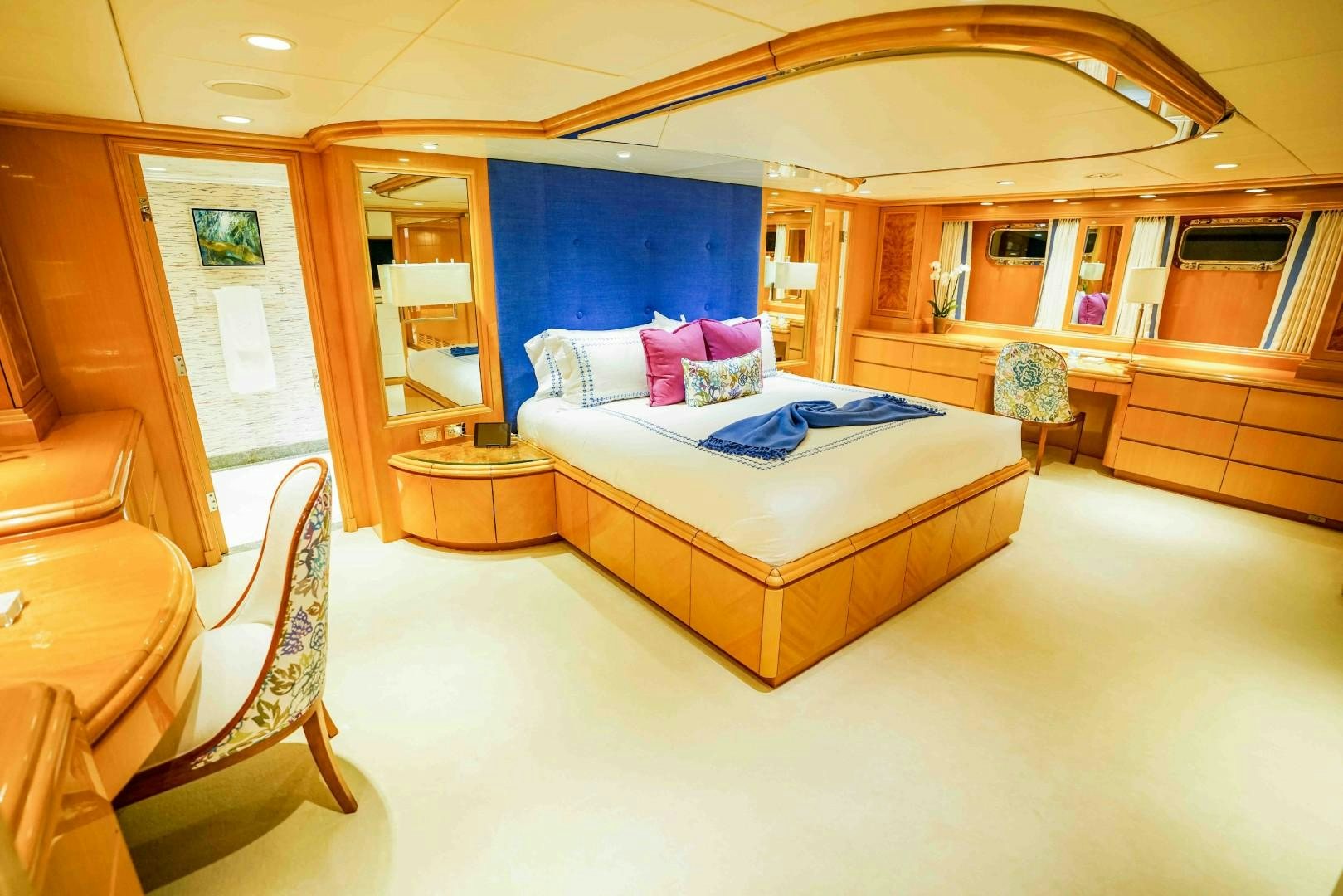 a bedroom with a bed and a chair aboard PROBABILTY Yacht for Sale