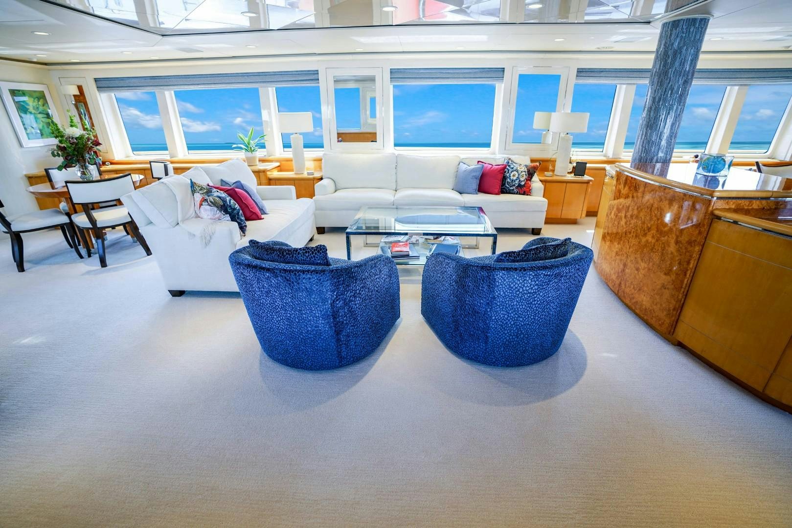 a living room with blue and white furniture aboard PROBABILTY Yacht for Sale