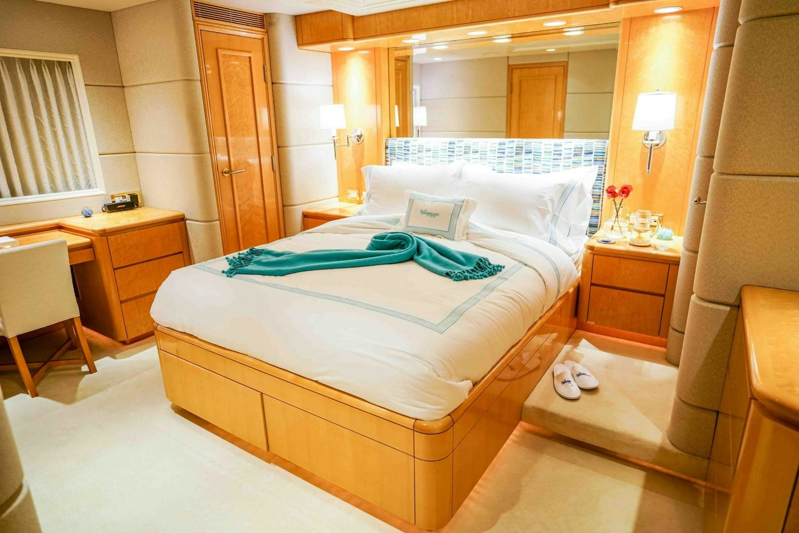 a bed with a blue sheet aboard PROBABILTY Yacht for Sale