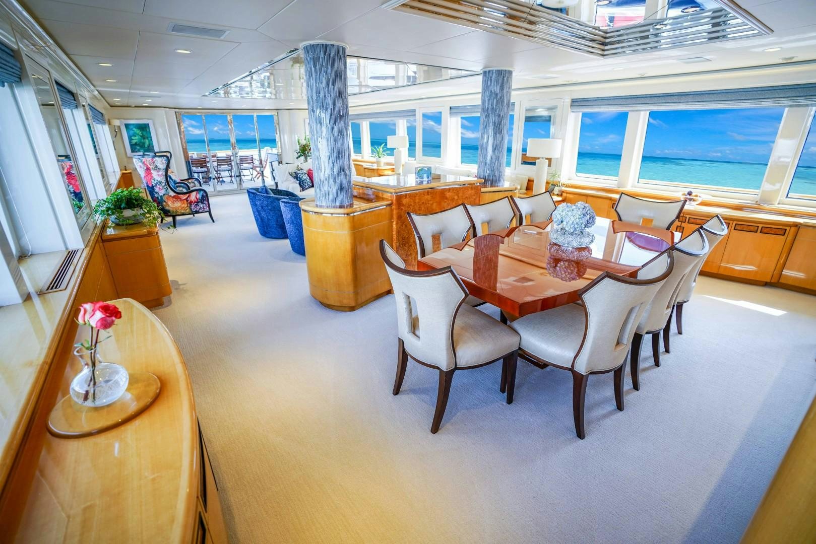 a room with tables and chairs aboard PROBABILTY Yacht for Sale
