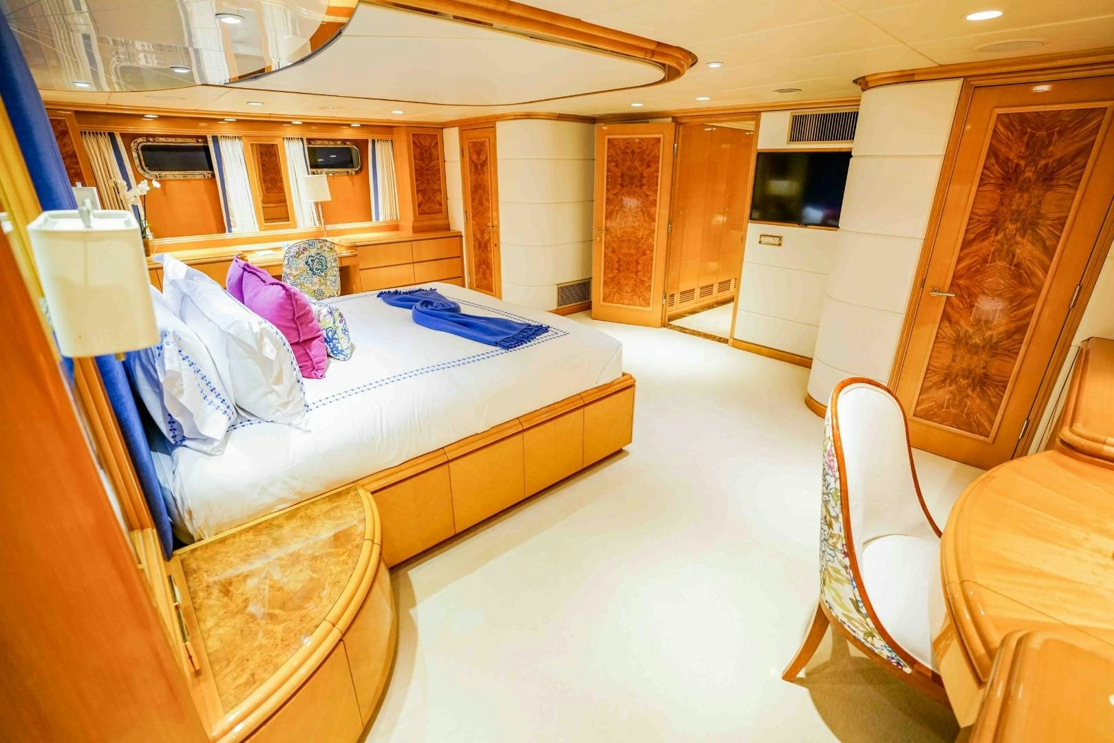 a bedroom with a bed and a chair aboard PROBABILTY Yacht for Sale