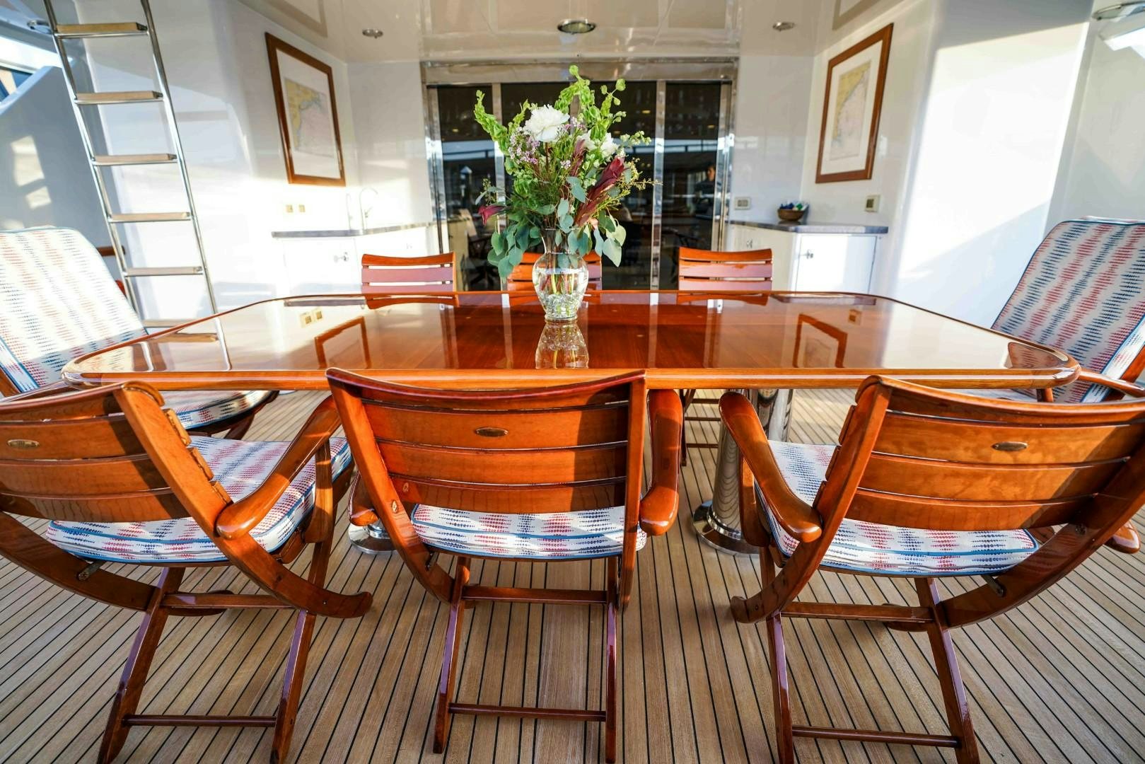 a dining room with chairs and a vase of flowers aboard PROBABILTY Yacht for Sale