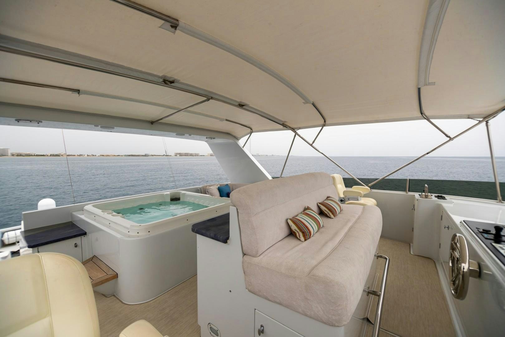 a boat with a bed and a chair on the deck aboard PROBABILTY Yacht for Sale