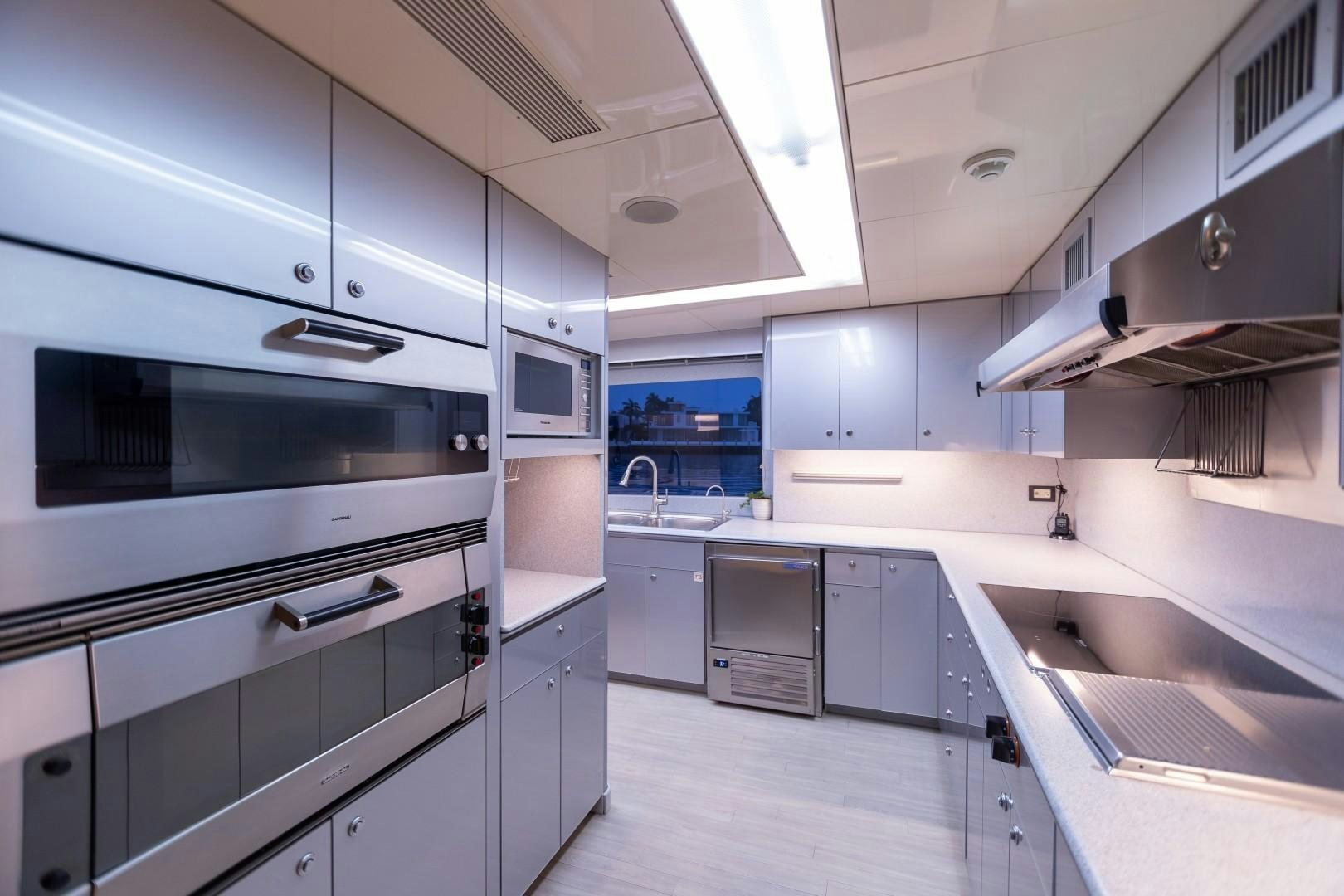a kitchen with white cabinets aboard PROBABILTY Yacht for Sale