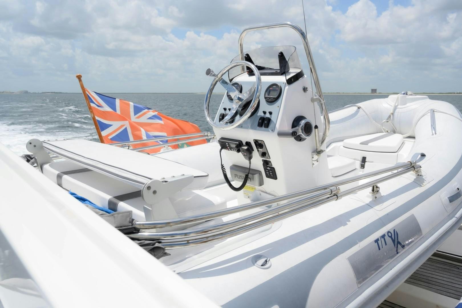 a boat with a flag on the front aboard VK Yacht for Sale