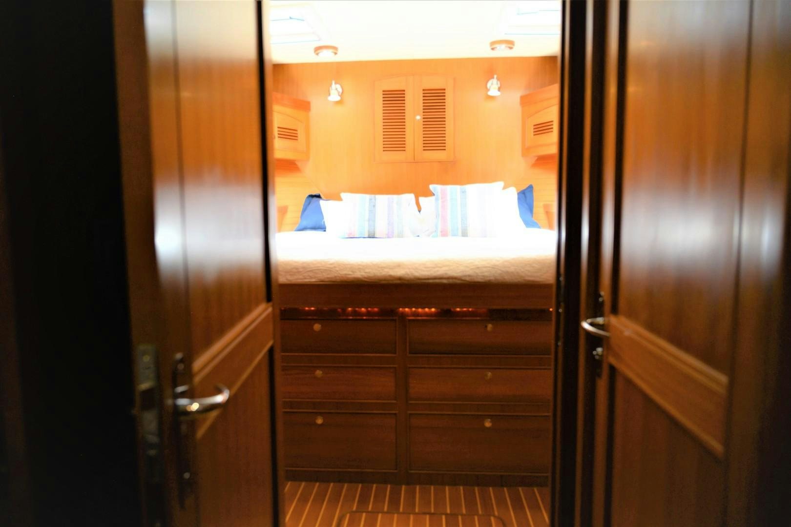 a room with a bed and a closet aboard VK Yacht for Sale