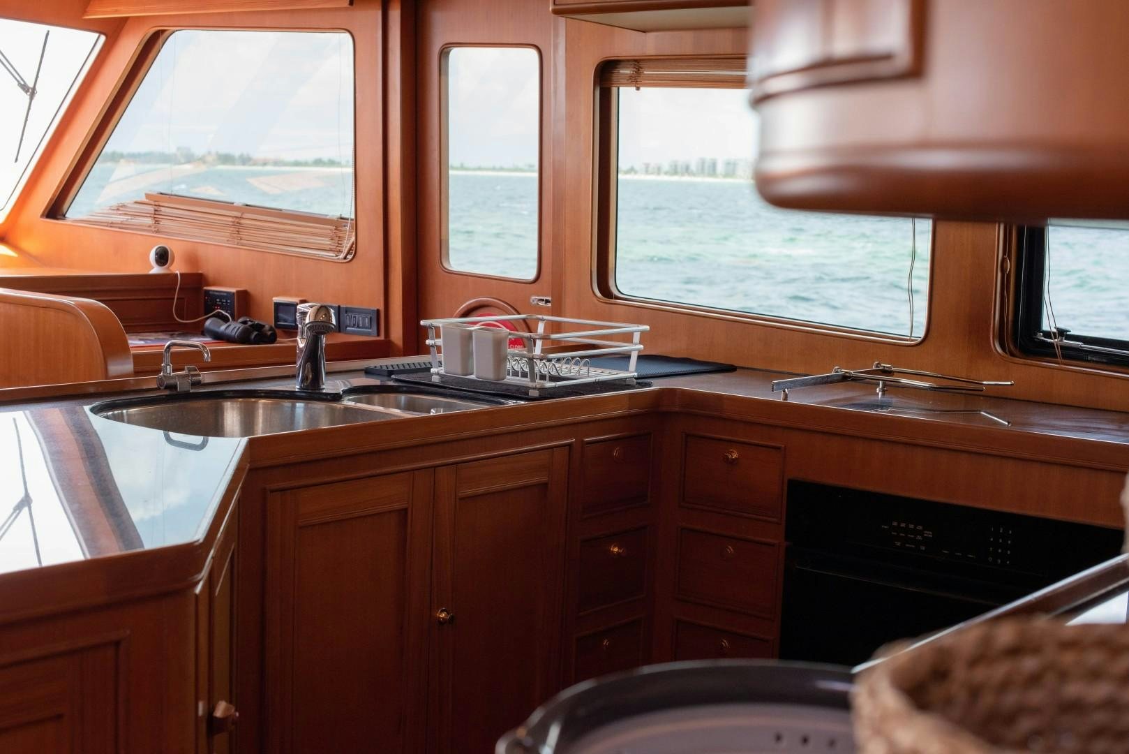 a kitchen with wooden cabinets aboard VK Yacht for Sale