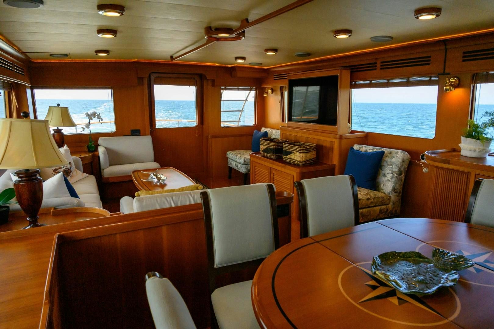 a living room with a table and chairs aboard VK Yacht for Sale