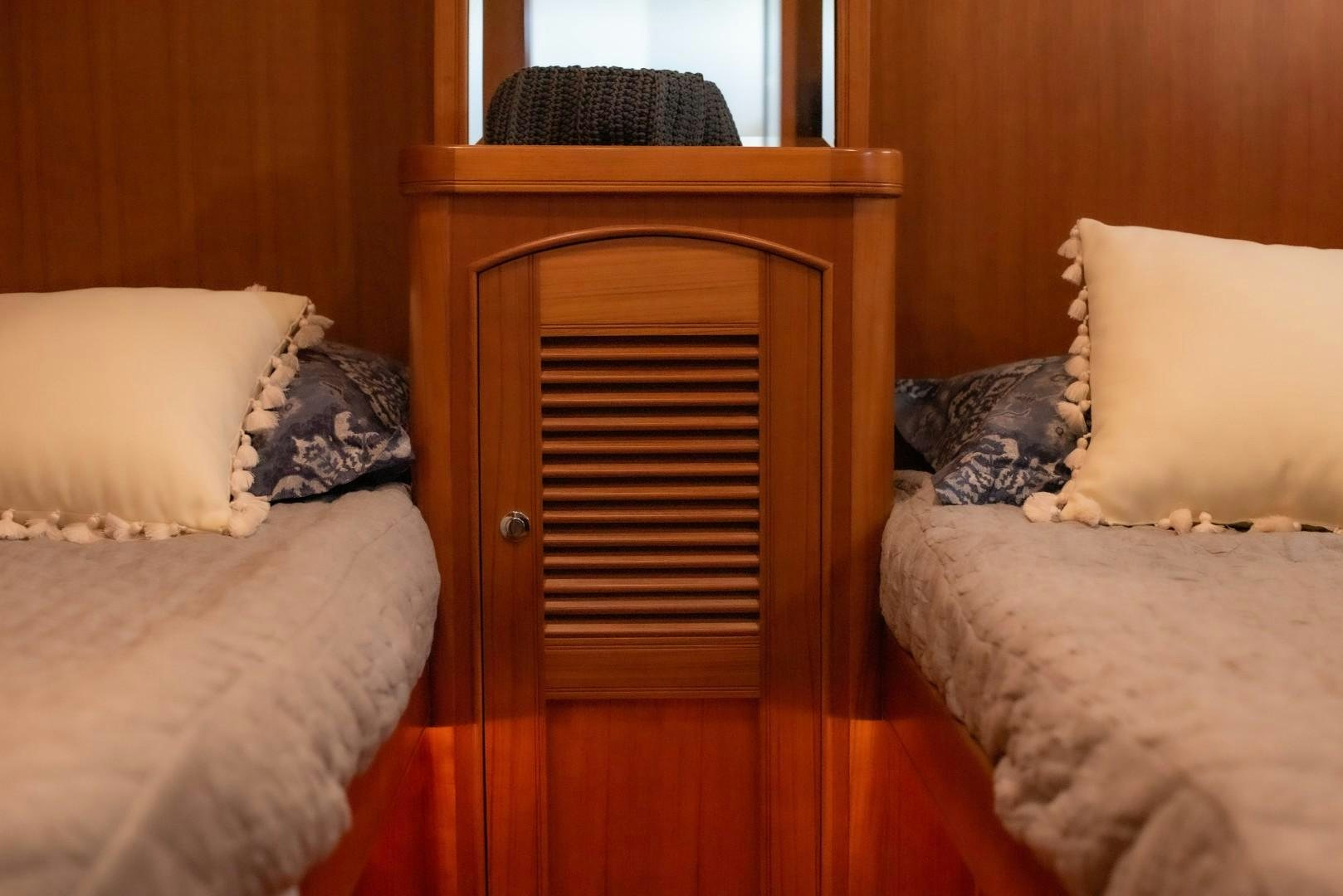 a bed with a wood headboard aboard VK Yacht for Sale