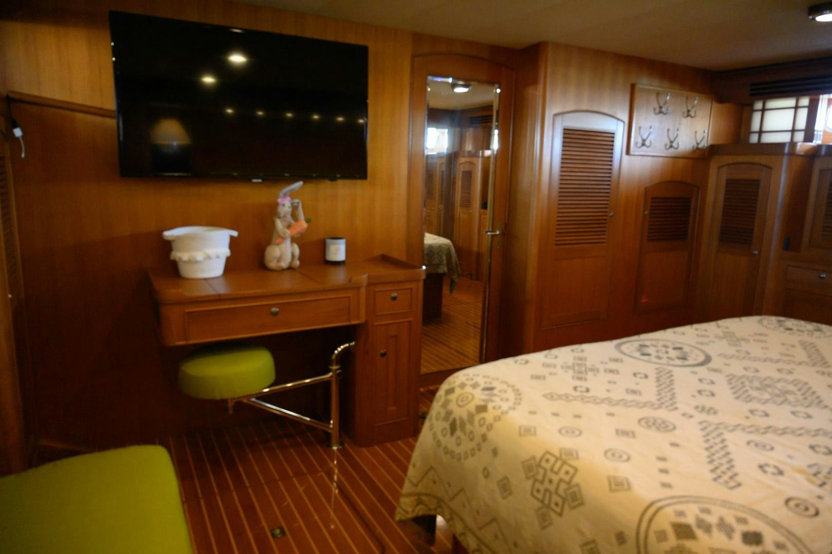 a bedroom with a bed and a desk aboard VK Yacht for Sale