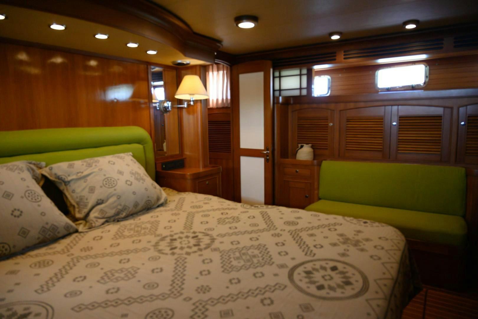 a bed with a white comforter aboard VK Yacht for Sale