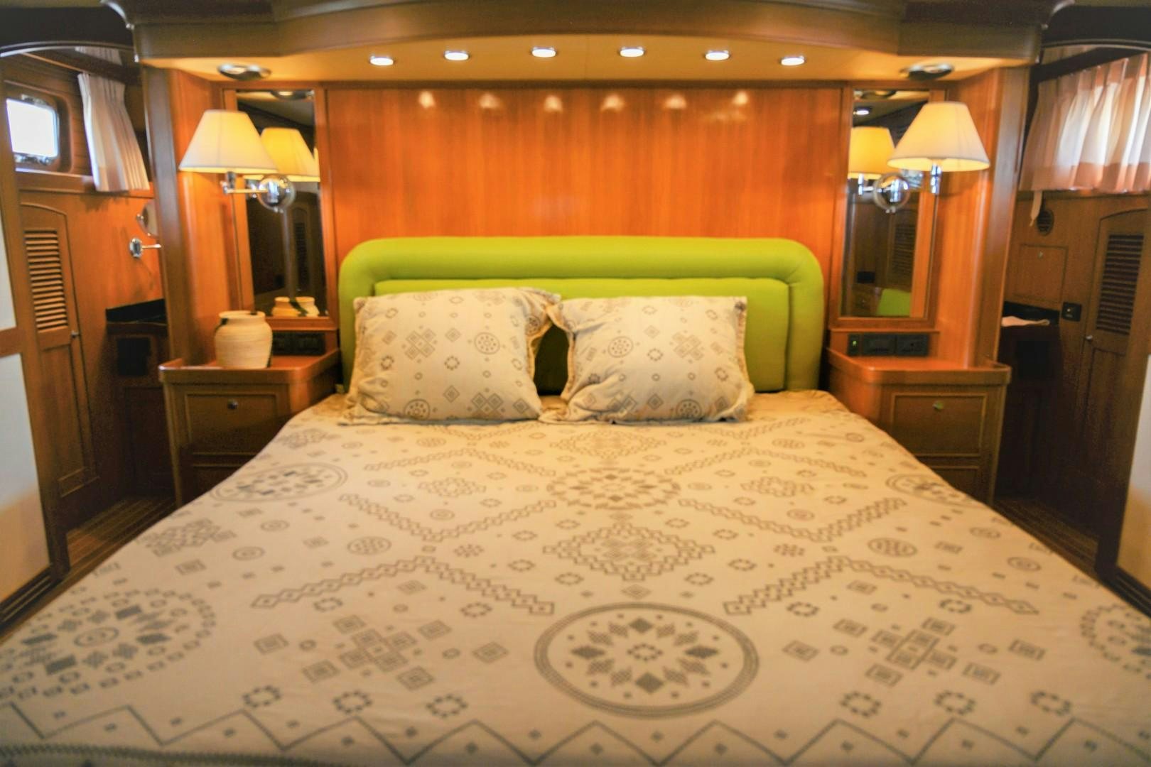 a bed with a white comforter aboard VK Yacht for Sale