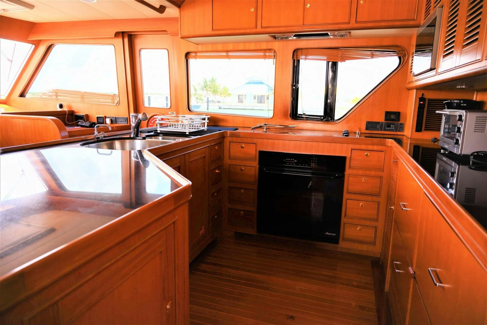 a kitchen with wooden cabinets aboard VK Yacht for Sale