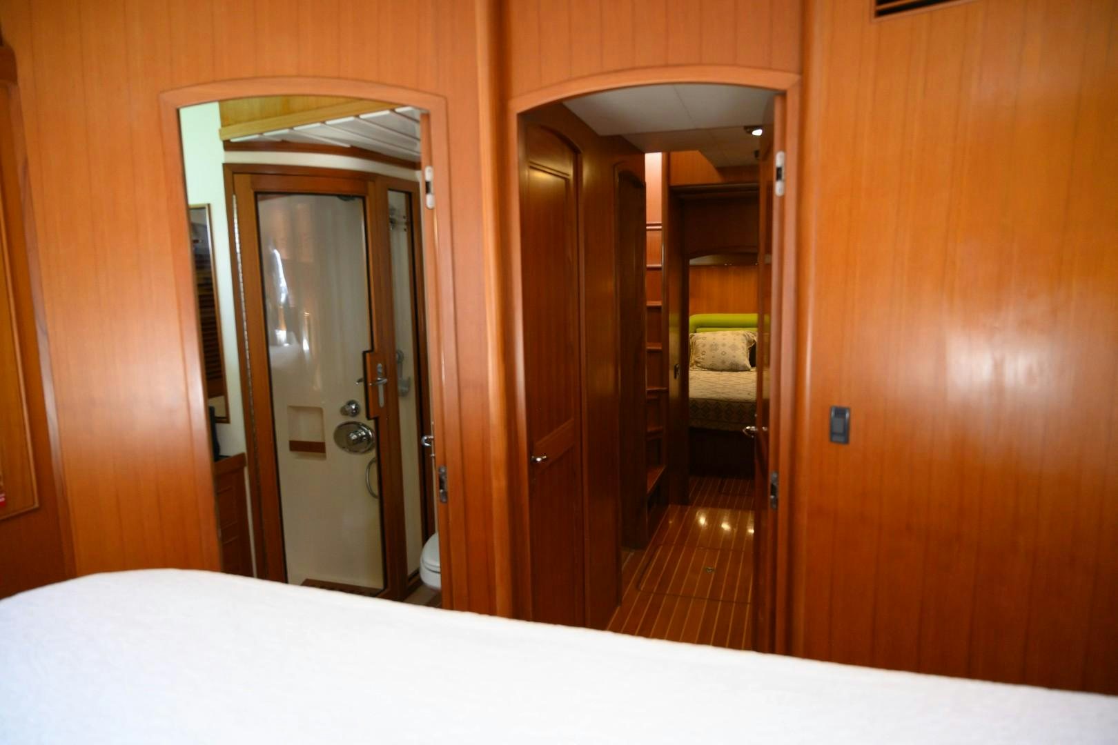 a room with a bed and a door aboard VK Yacht for Sale