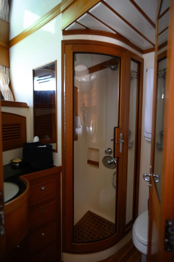 a bathroom with a glass shower aboard VK Yacht for Sale