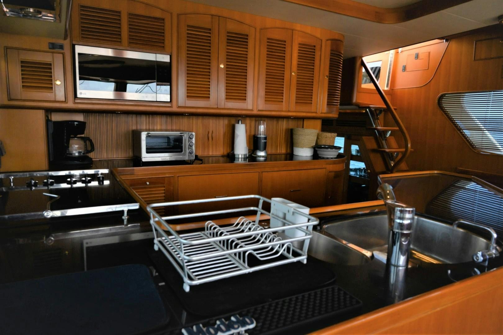 a kitchen with wooden cabinets aboard VK Yacht for Sale