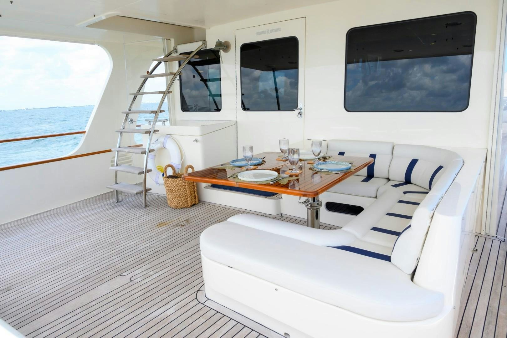 a room with a table and a tv on the wall aboard VK Yacht for Sale