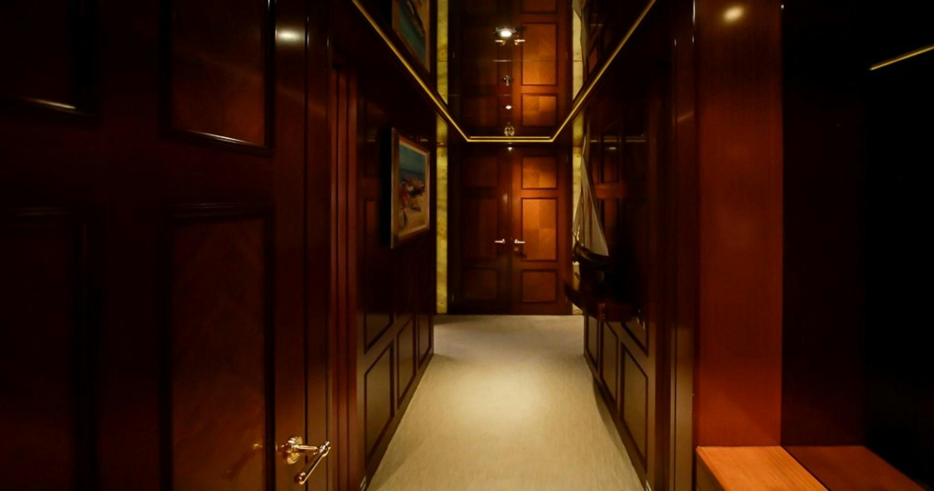 a hallway with a row of doors aboard BLUE MOON Yacht for Sale