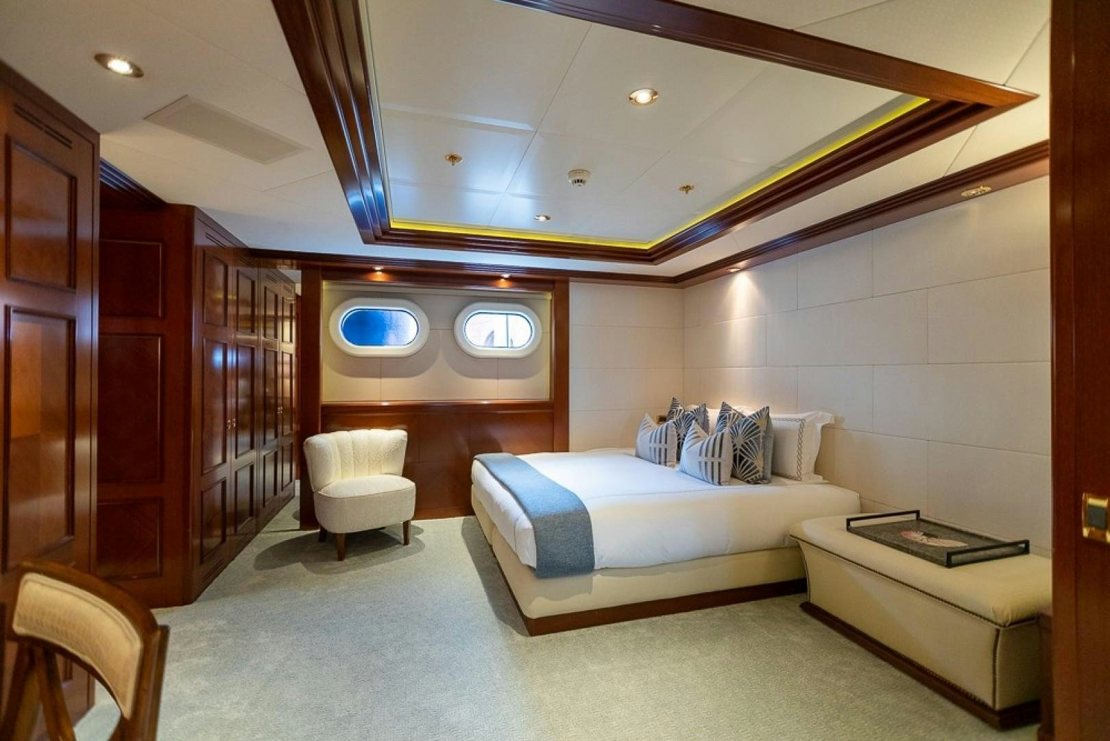 a room with a bed and a couch aboard BLUE MOON Yacht for Sale