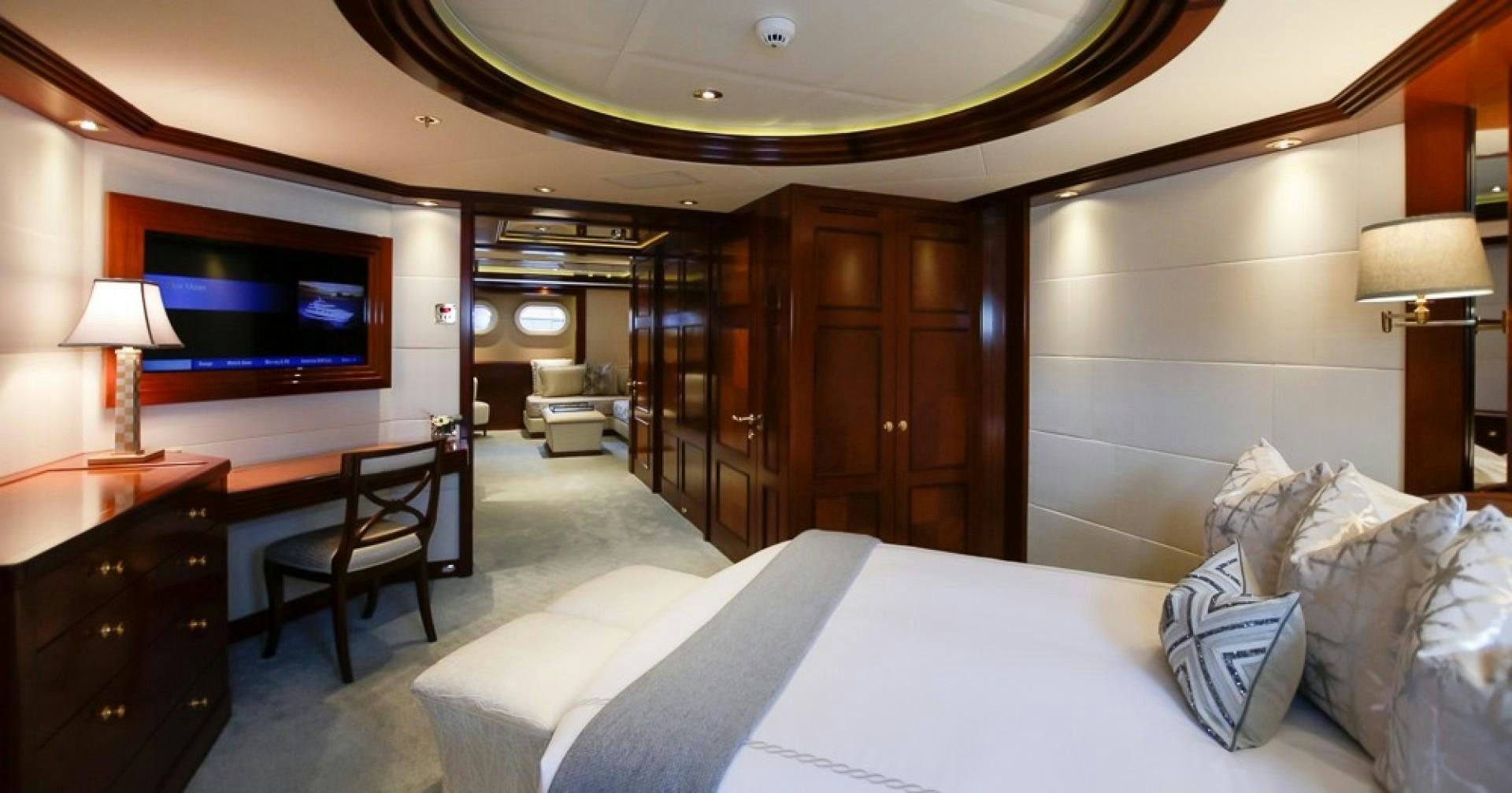 a hotel room with a bed and a tv aboard BLUE MOON Yacht for Sale
