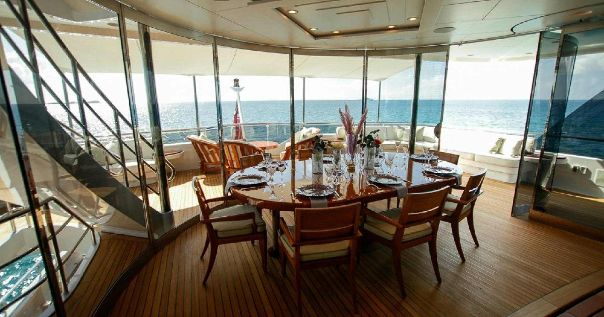 a dining room with a table and chairs aboard BLUE MOON Yacht for Sale