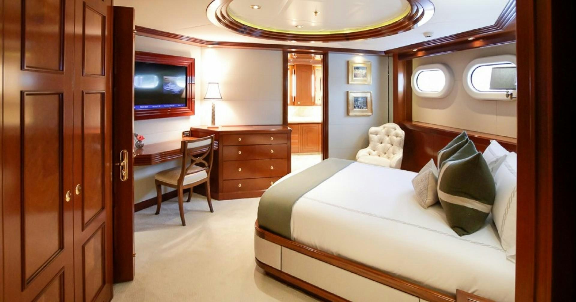 a bedroom with a bed and a television aboard BLUE MOON Yacht for Sale