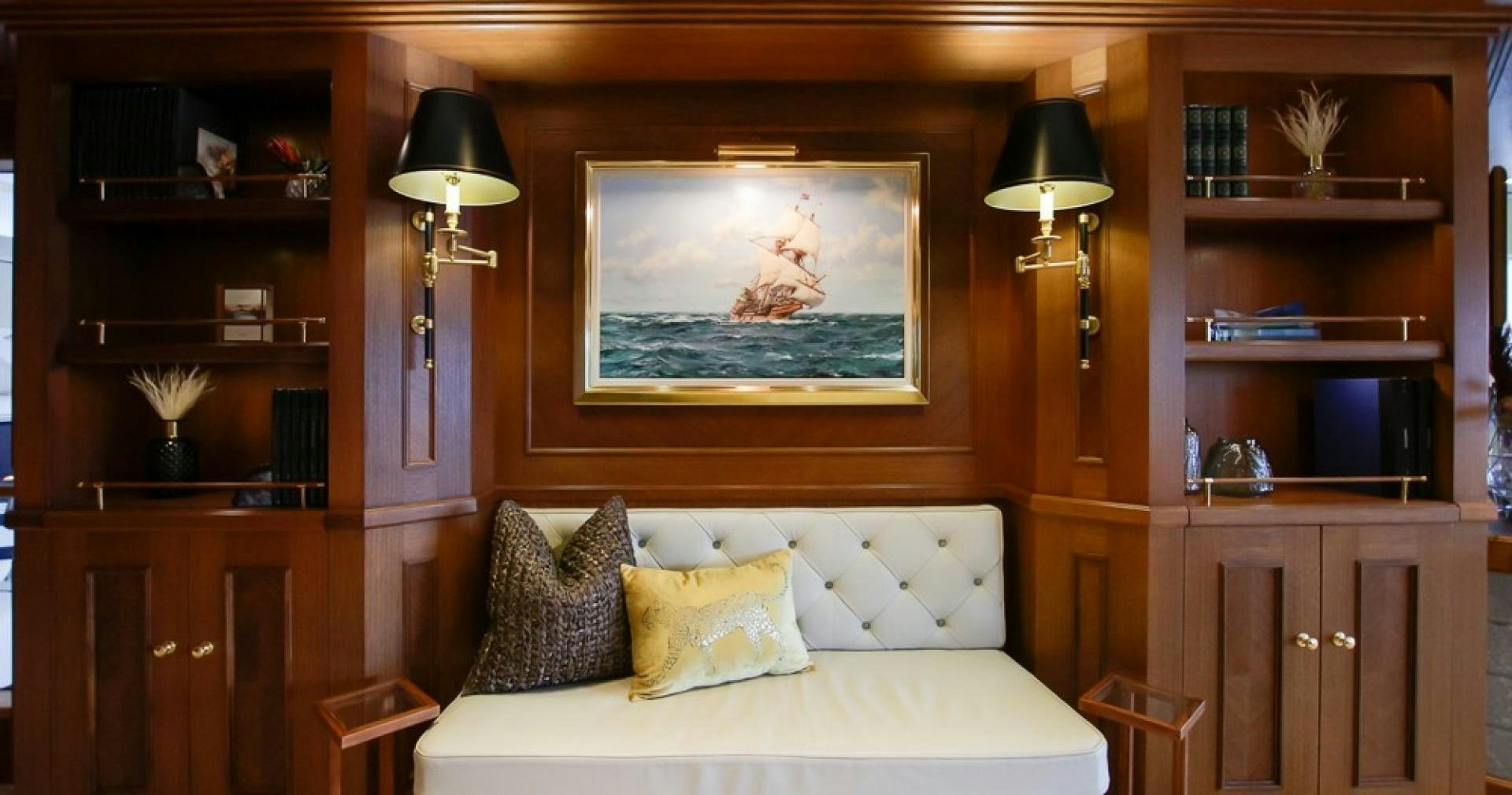 a bed with a painting on the wall aboard BLUE MOON Yacht for Sale