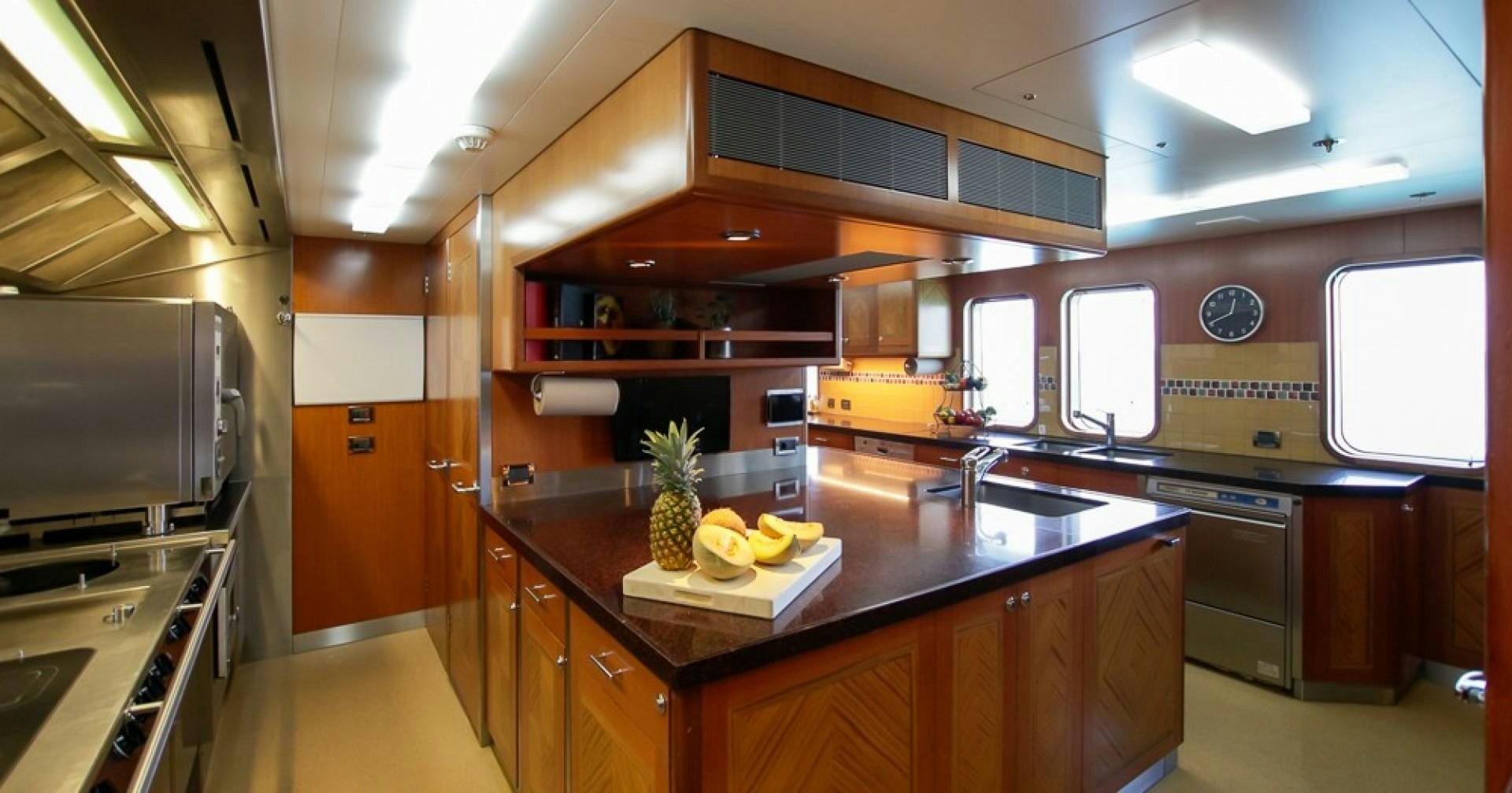 a kitchen with a large island aboard BLUE MOON Yacht for Sale