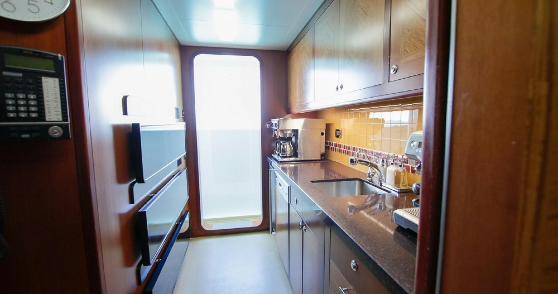 a kitchen with a sink and cabinets aboard BLUE MOON Yacht for Sale