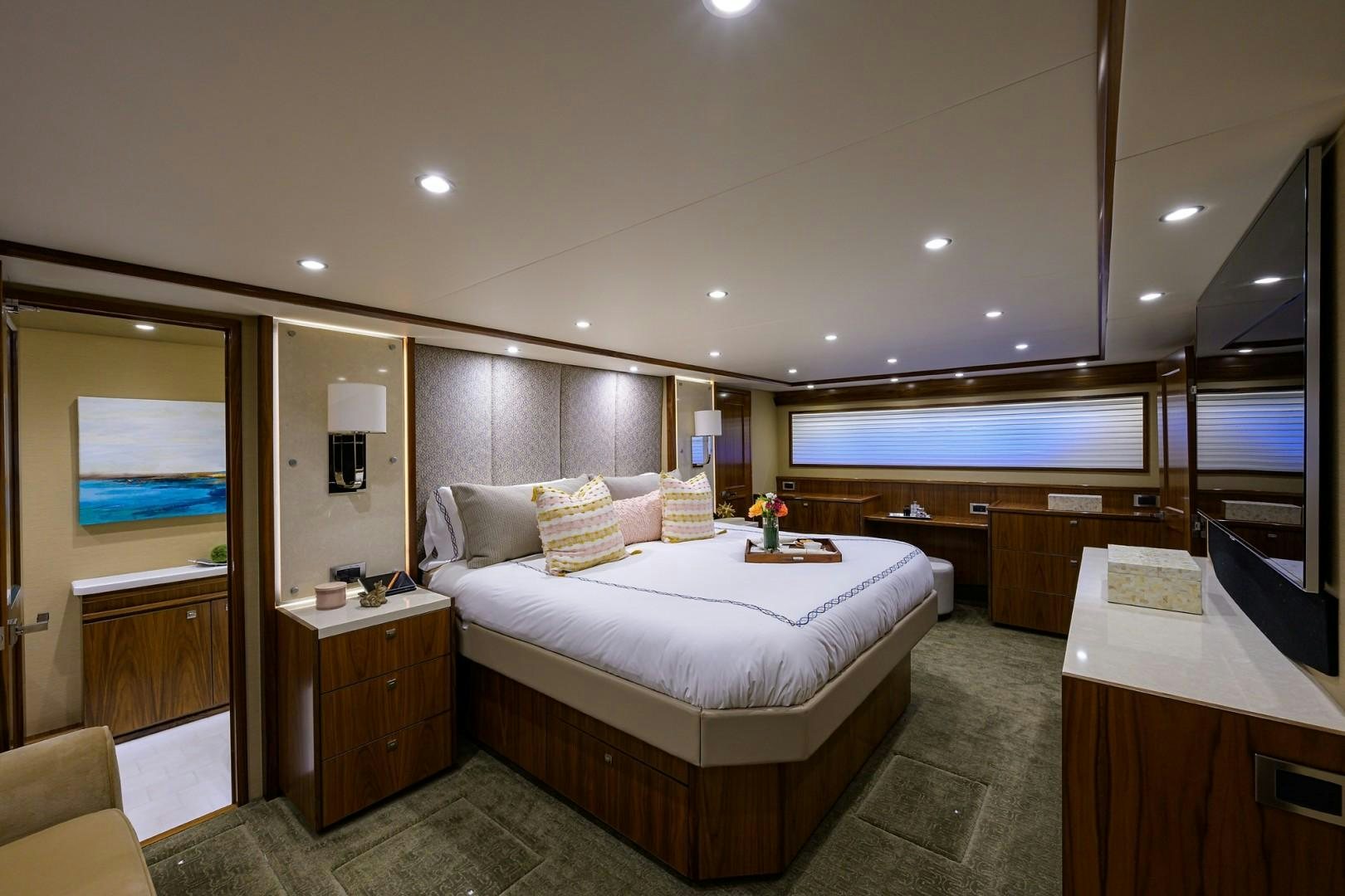 a room with a bed and a desk aboard NIKKI BELLA Yacht for Sale