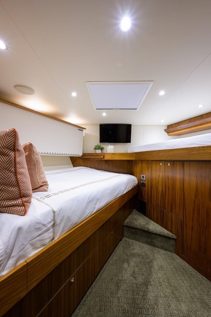 a room with a bed and a television aboard NIKKI BELLA Yacht for Sale