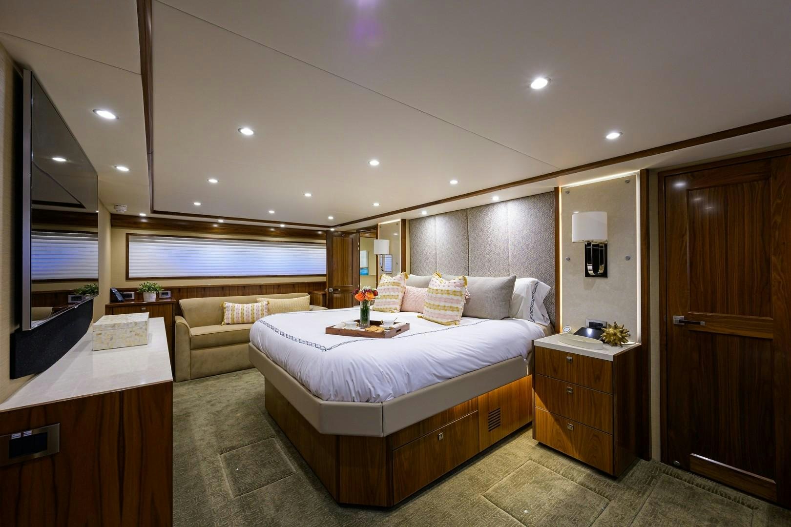 a bedroom with a bed and a desk aboard NIKKI BELLA Yacht for Sale