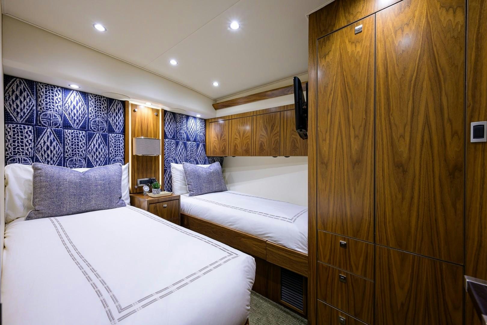 a room with a bed and a closet aboard NIKKI BELLA Yacht for Sale