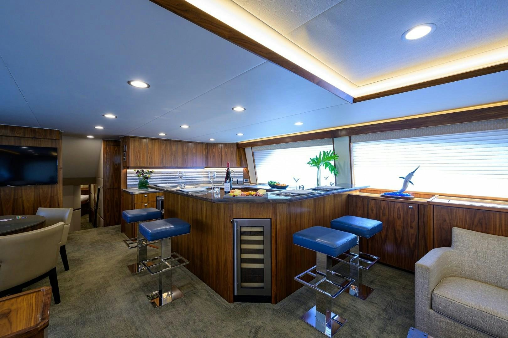 a room with a desk and chairs aboard NIKKI BELLA Yacht for Sale