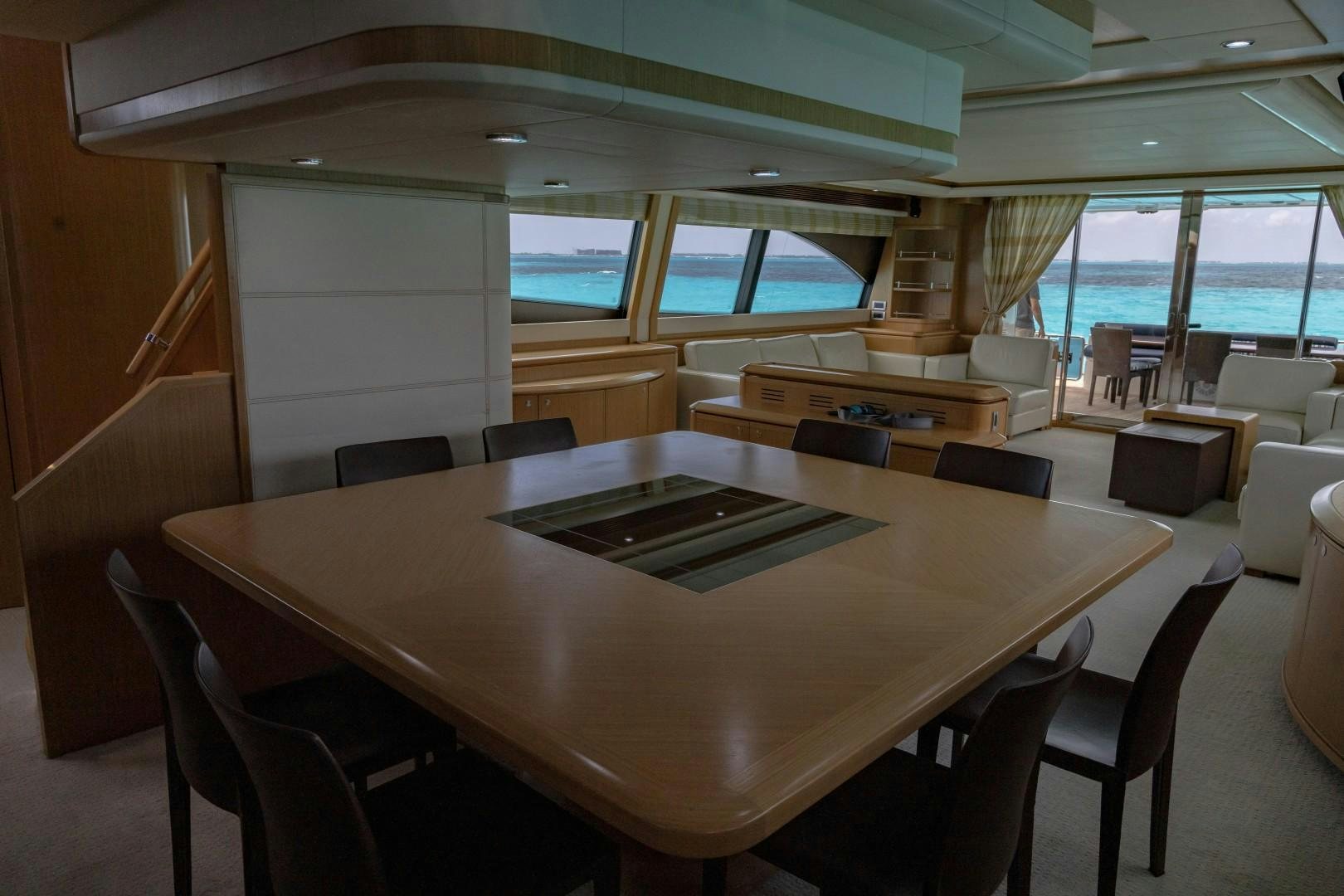 a conference room with a table and chairs aboard FORTIS II Yacht for Sale