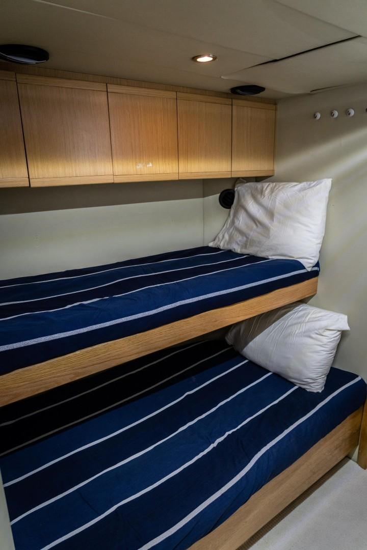 a bed with white sheets aboard FORTIS II Yacht for Sale