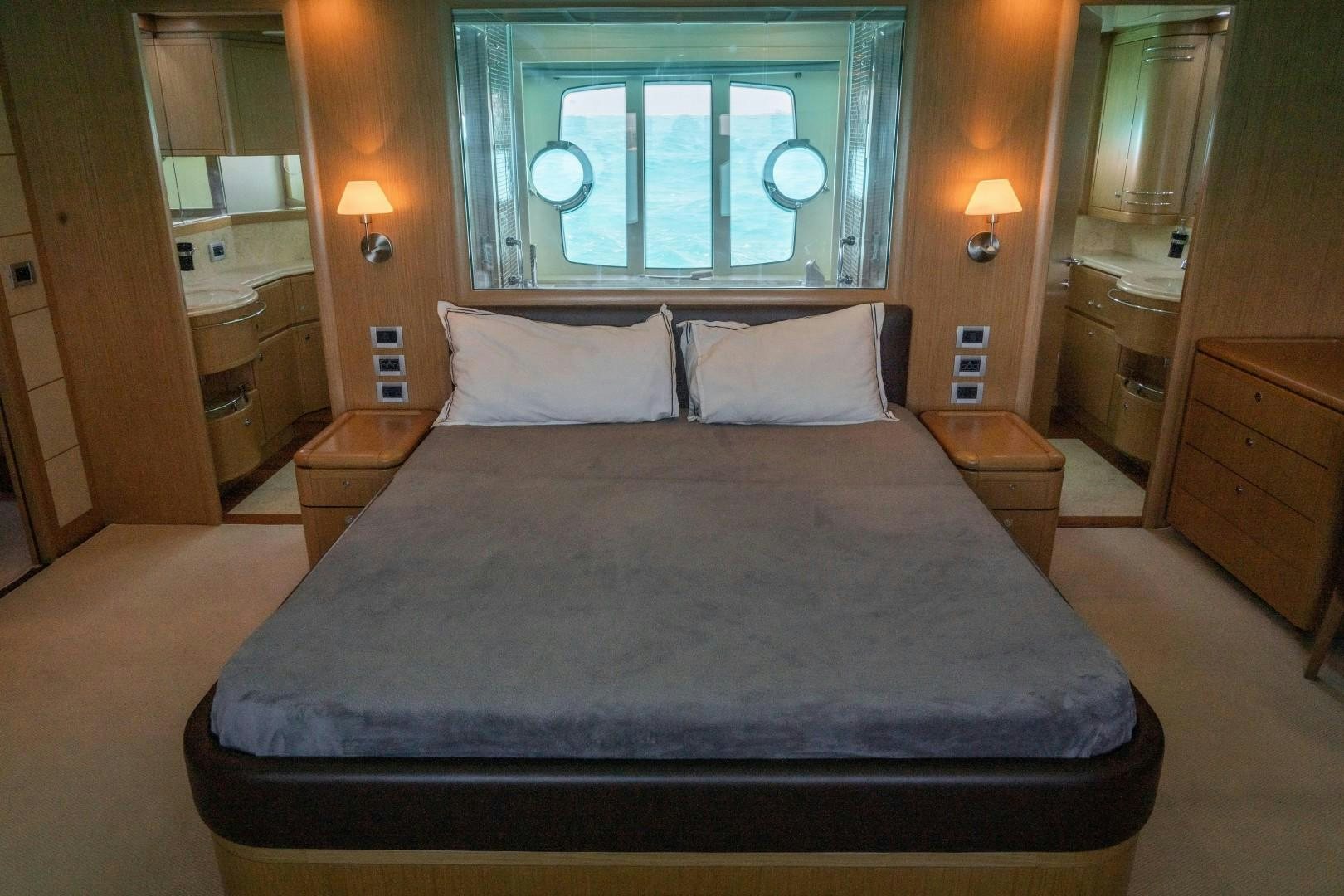 a bed with a blue sheet aboard FORTIS II Yacht for Sale