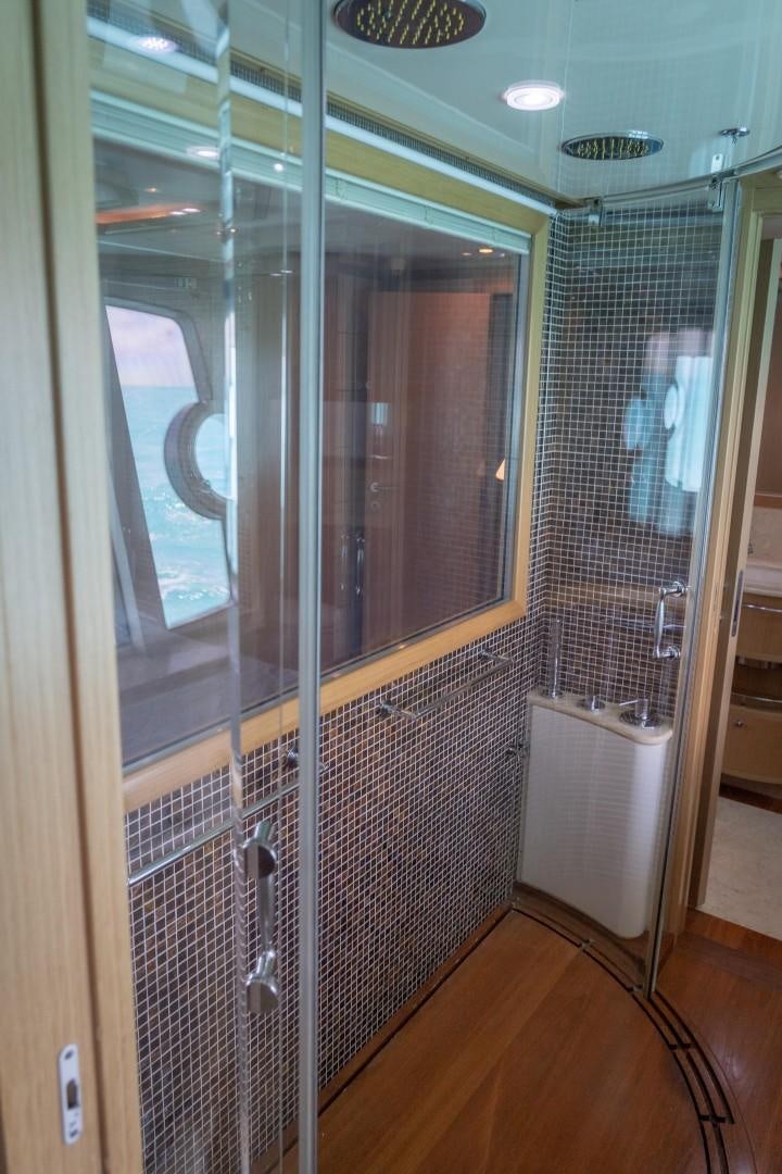 a bathroom with a glass shower aboard FORTIS II Yacht for Sale